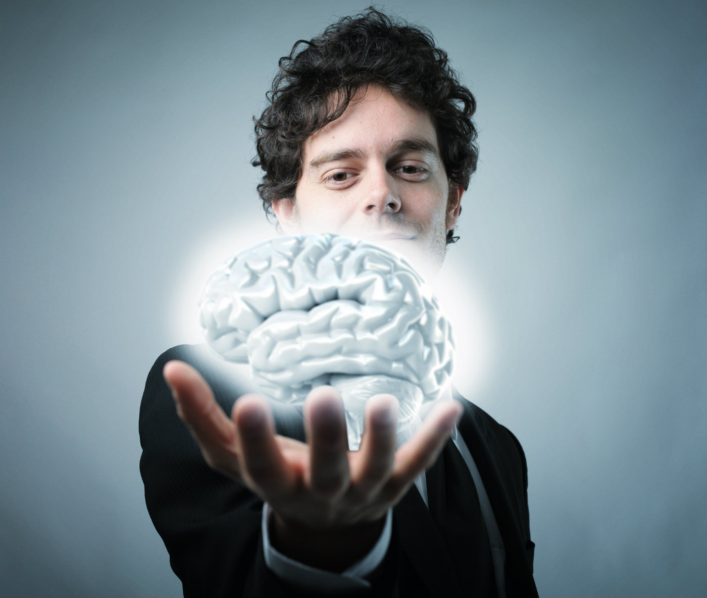 guy holding a glowing brain