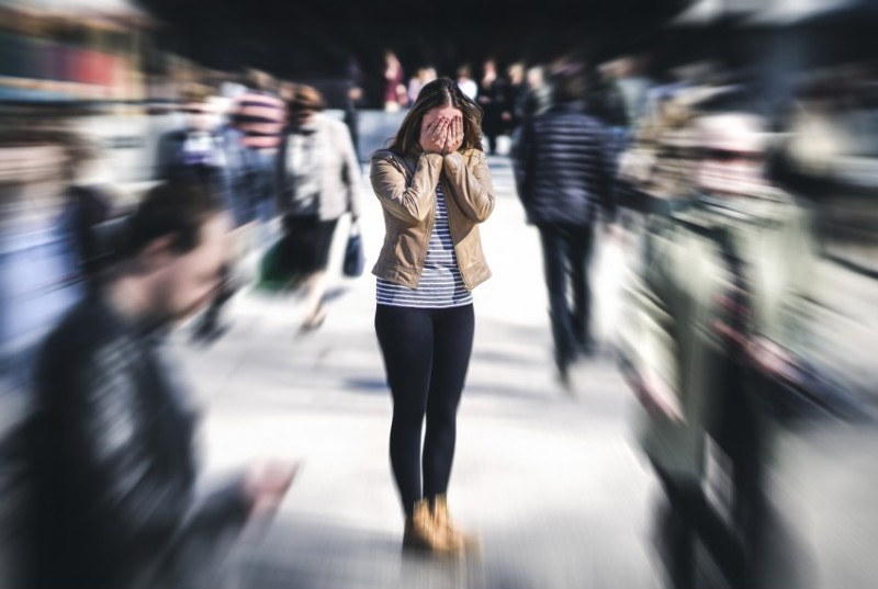 woman experiencing anxiety in a crowd of people